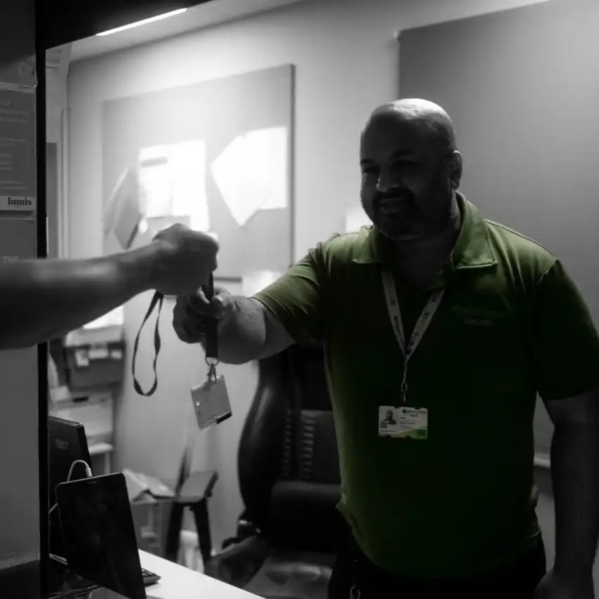 Security guard handing out a pass